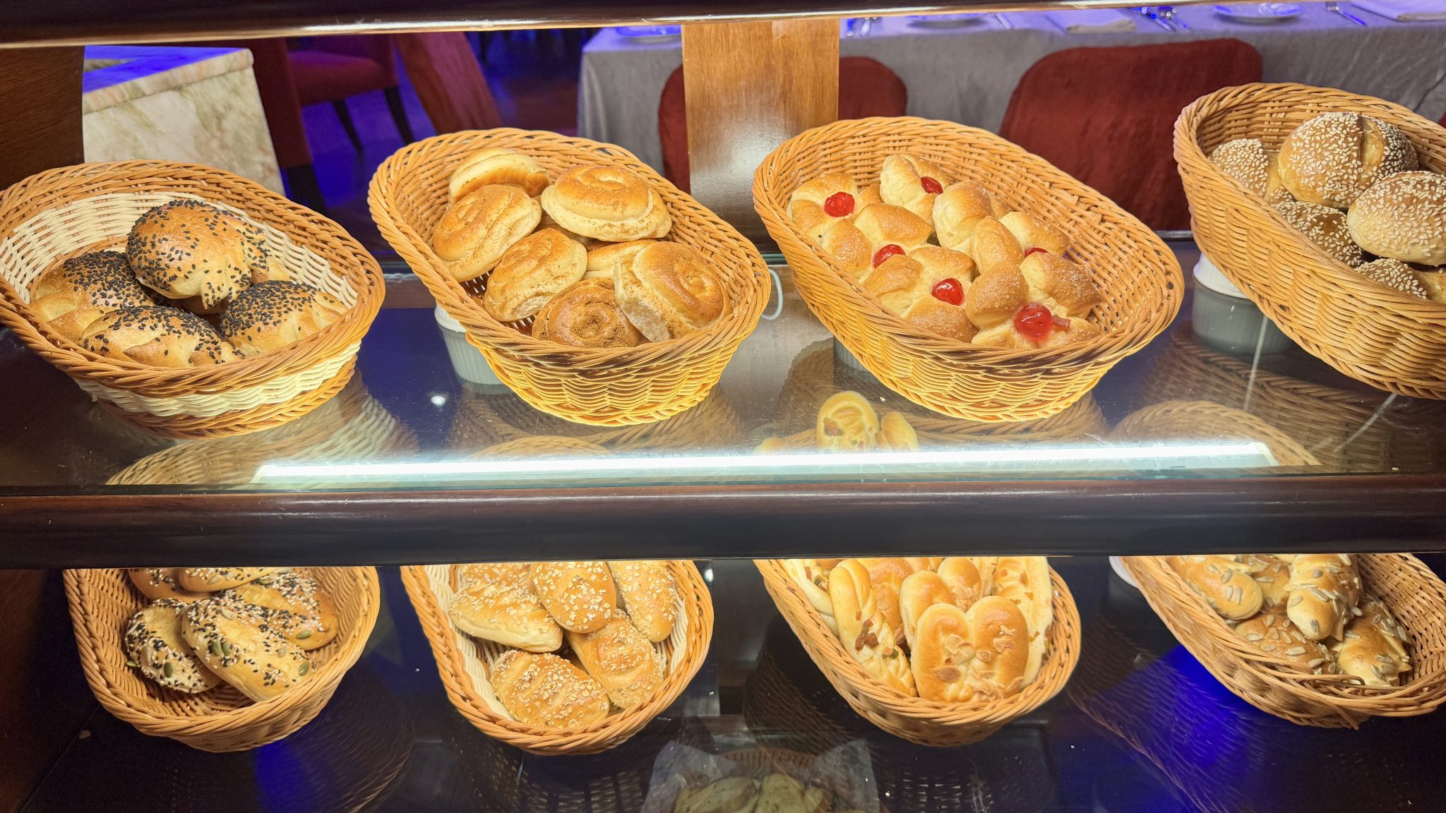 A bakery shelf of fresh bread rolls.